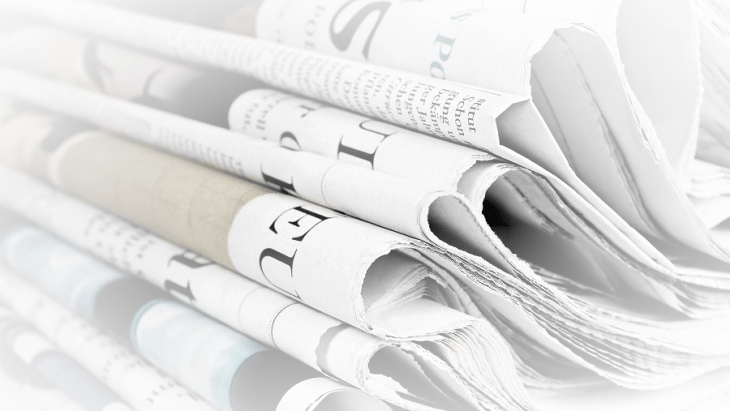 a pile of folded newspapers